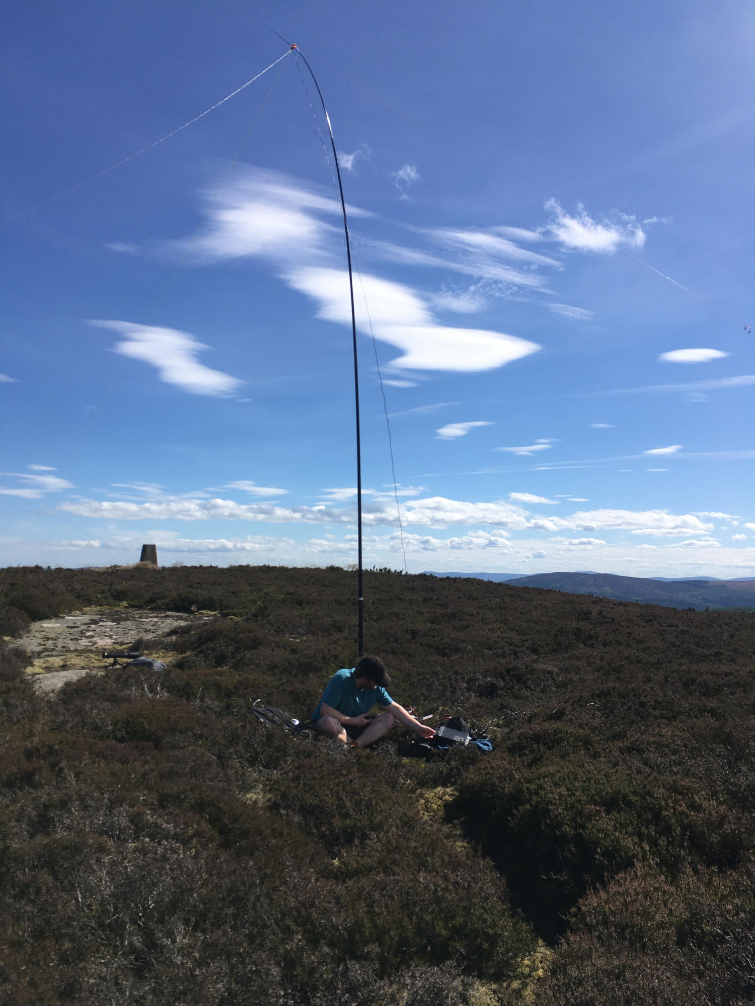 Me, sat at the base of a mast operating a radio on a beautiful day